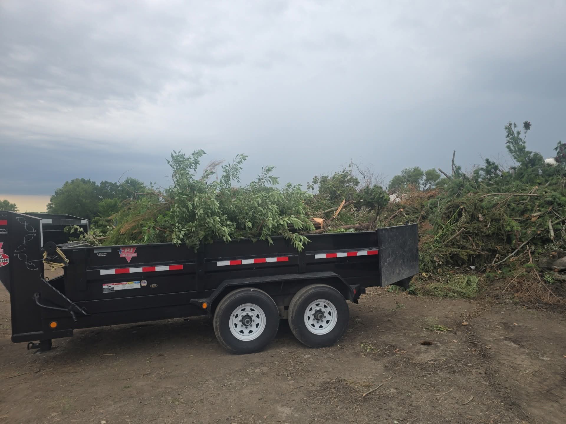 Dump trailer loaded with yard debris for removal
