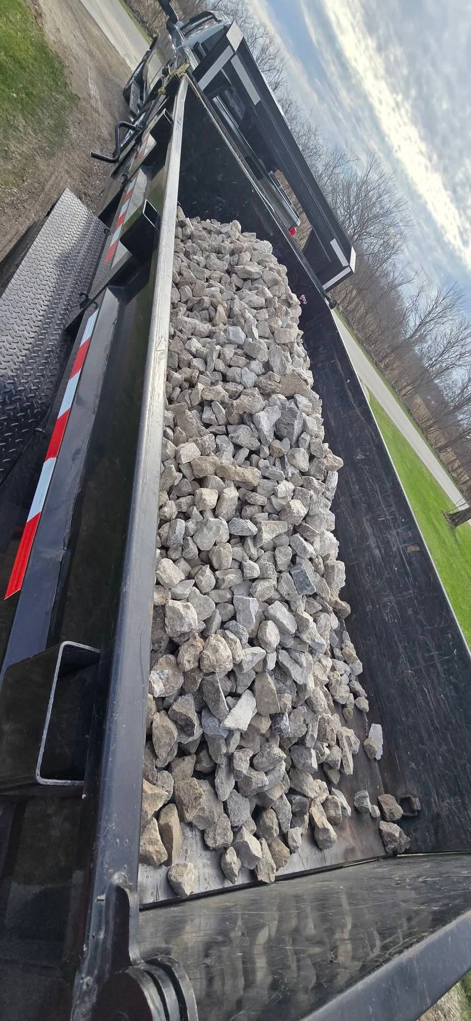 Overhead view of dump trailer full of stone